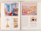 an open book with a drawing of a living room in it