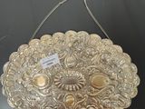 a silver purse that is on a black table