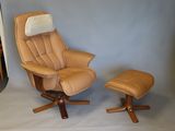 beige leather reclining chair with footstool and ottoman in front of a blue wall