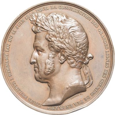 an image of a bronze medal with a man ' s head on it