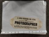 a white bag with a picture of a photographer on it