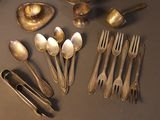 many silver spoons and spoon spoons on a table