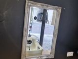 a bathroom with a sink and a mirror on the wall