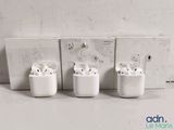 three airpods sitting next to each other on a shelf