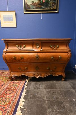 une commode dans une pièce où il y a un tapis au sol