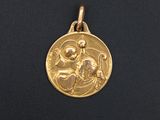a close up of a gold medal on a black surface