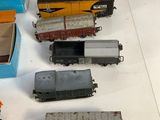 several toy trains are sitting on a table next to a box