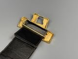 a black leather belt with a gold buckle on it