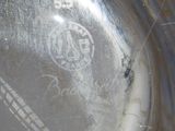 a close up of a silver plate with writing on it