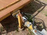 a flatbed trailer that is sitting in the dirt