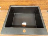 an image of a black sink on a wooden floor