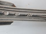 an old silver plate with a fork and knife on it