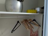 a pot and pan on a shelf in a closet