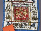 a close up of a square scarf with a red and blue design
