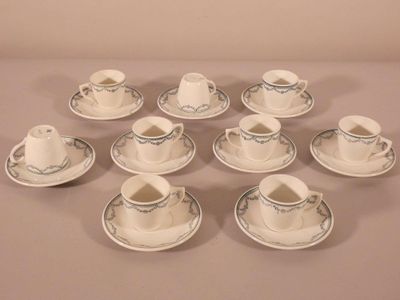 nine cups and saucers on the table with saucers