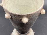 a black and white vase sitting on top of a table