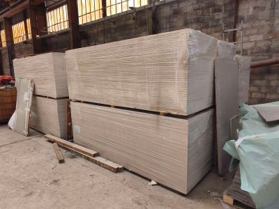 many stacks of cardboard stacked on top of each other in a warehouse