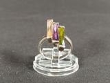 purple and green tourmaline ring on a clear acrylic stand