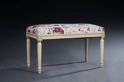 a small bench with a floral upholstered seat on it