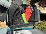 a piece of luggage sitting on the ground next to a pile of trash