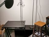 a desk with a chair and a lamp in a room