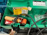 a green box with tools in it sitting on a table
