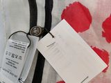 a close up of a red and white bag with a tag on it