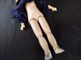a doll that is laying on a black surface