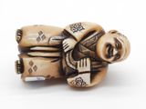 a figurine of a man sitting on a chair