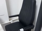 a black chair that is sitting in a hospital room