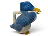a small blue and white bird with a yellow beak