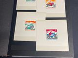 four different stamps are displayed in a display case on a table