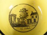 a yellow bowl with a picture of a farm on it