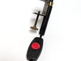 a red button on the handle of a black stick