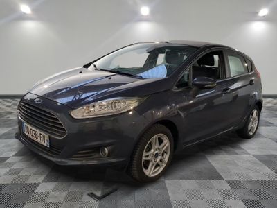 the ford fiesta is parked on a checkered floor in a showroom