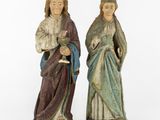 two statues of jesus and mary are standing next to each other