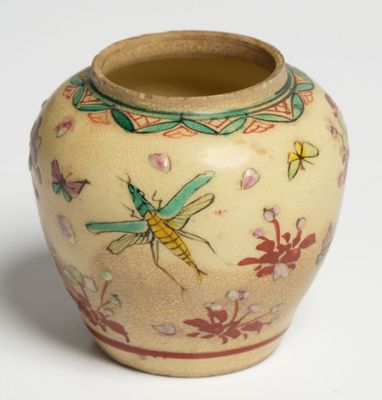 a small vase with a dragonfly painted on it