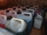 many different colors of plastic containers lined up on a counter