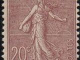 a stamp with a woman holding a basket on it