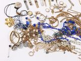 many different types of jewelry on a white surface