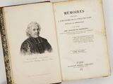 an old book with a picture of a man in a black coat