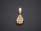 a gold pendant with a flower design on it