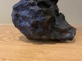a rock that is sitting on a wooden table