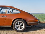 an orange car parked on the side of the road