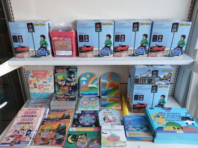 many children ' s books on a shelf in a room