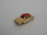 yellow toy car with a red roof on a white surface