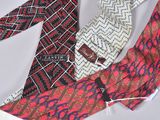 several ties are laid out on a white surface with a tag on them