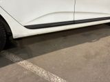 a picture of a white car parked in a parking lot