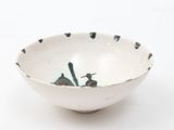 a white bowl with black and white designs on it