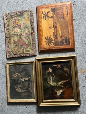 quatre tableaux encadrés accrochés au mur d'une pièce où se trouve un chat